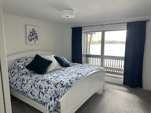 Bedroom 1 with a king sized bed and lake views.  All bedrooms are located on the main level.