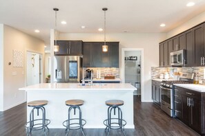 Have a few drinks at the kitchen island before sitting down for a gourmet meal at the dining table.