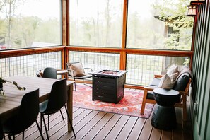Our cabin offers its own outdoor sanctuary for guests. Breathe in the mountain air from the porche or unwind by the outdoor propane fire table. With ample seating areas, guests can sip morning coffee or enjoy a sunset drink. A large outdoor dining table invites al fresco meals.