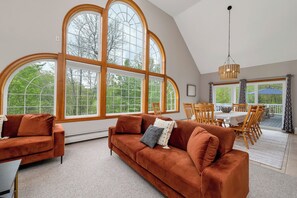 Beautiful living space with windows looking out to backyard and pond