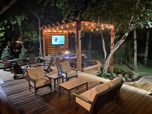 Outdoor kitchen and bar with several sitting areas.  