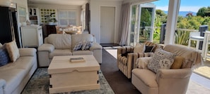 Relaxed coastal vibe in the lounge flows through to open plan dining and kitchen