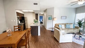 Open-concept living! Seamless flow from the fully equipped kitchen to the comfortable living and dining areas.