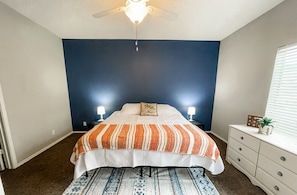 Spread out in the spacious master bedroom with a comfortable King size bed, dresser, and a closet to stow personal items.