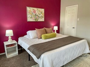 Vibrant and beautifully decorated space with a striking pink wall, adding warmth and charm!