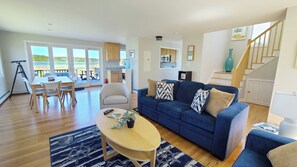 Living room with steps to second floor beyond