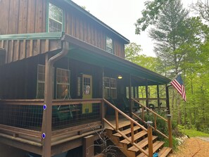 Three-sided wrap around porch, two of the sides fully screened in for protection