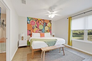 Primary bedroom with en suite bath and gorgeous wall mural. 