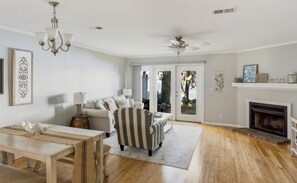 Living room with sofa, chairs, and fireplace and a clear view of the water!
