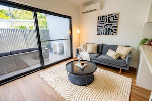 Light Filled Living Room opening up to our spacious and sunny patio.