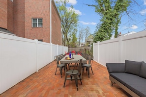 Escape to your stylish oasis with serene outdoor space and seating