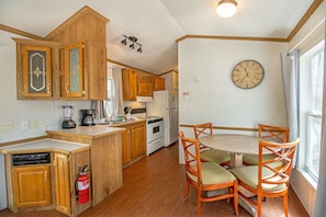 The open floor plan leads into the partial kitchen