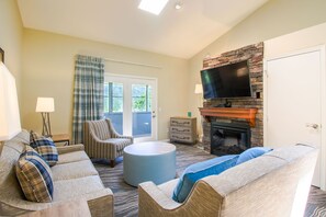 And living area with a stone fireplace