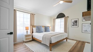Primary Bedroom with King Bed, ensuite bathroom with soaking tub and shower, balcony, and smart tv.