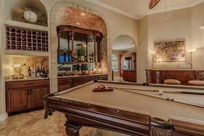 Game Lounge - - Enjoy a game of pool surrounded by the warm ambiance of this elegant space
- Indulge in your favorite drinks from the beautifully designed bar and wine rack
- Perfect for entertaining guests, unwinding, and creating unforgettable memories