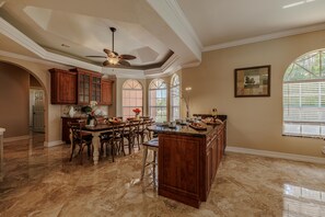 Dining Elegance - - Gather around the beautifully crafted dining table, perfect for family meals or celebrations
- Enjoy the open kitchen layout with a central island and abundant natural light
- Warm and inviting space for cooking, dining, and creating lasting memories