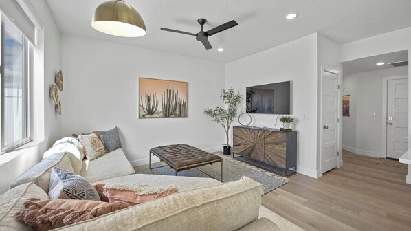 Gather and relax. Curl up on the comfortable couches and enjoy a movie night on the Smart TV in the living room.