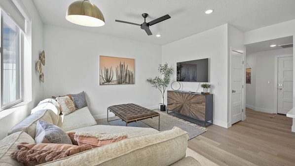 Gather and relax. Curl up on the comfortable couches and enjoy a movie night on the Smart TV in the living room.