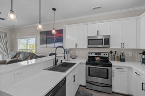 Our kitchen is a chef's paradise boasting sleek countertops 