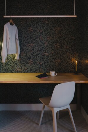 Work space in bedroom doubles as closet space.