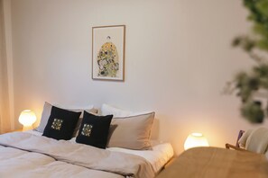 King bed with linen duvet and soft lighting.