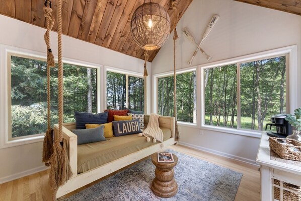 Our 'Swing Room' has a cozy swing and a coffee bar. It's a great spot for sipping morning coffee or reading. Learn more about our guest experience at truenorthpocono.com! 
