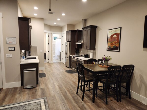 Full size kitchen. Showing location of dining room table and access to 2nd bathroom and bedroom.