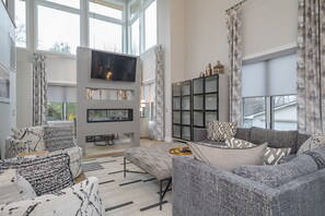 Living room with double-sided gas fireplace and TV for streaming