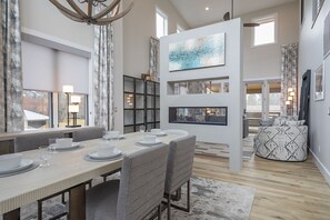 Dining area with seating for 6 and double-sided gas fireplace. Note: there is an extendable leaf for the dining table (stored in the King bedroom closet) to accommodate 8-10 people.