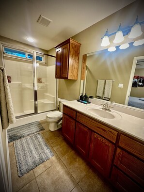 Master bathroom with enclosed shower.