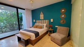 Bedroom with queen sized bed and lounge chair