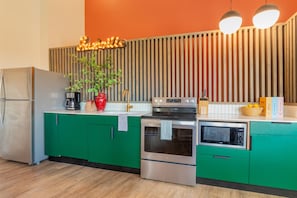 Stylish kitchen boasts vibrant pops of color.