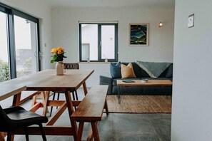 Dining Area + Lounge View (Middle Left) Ty Melyn Newgale – Gather around the spacious dining table or relax in the adjacent living space with a glass of wine and great company.