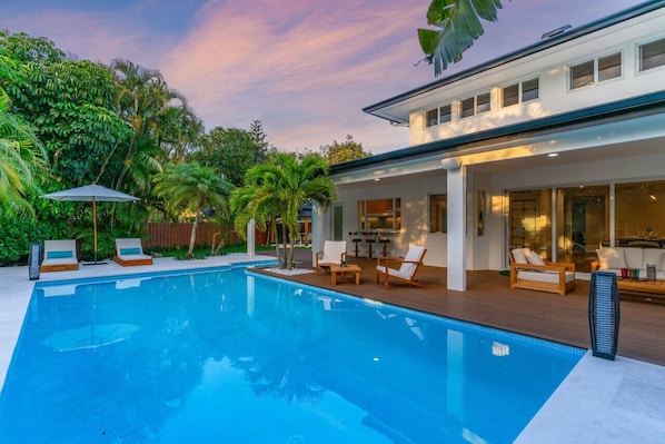 Escape to your private paradise: lounge by the poolside as the sunset paints the sky, in the comfort of our tropical haven.