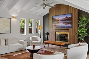 Experience the fusion of luxury and comfort in this stylish living space, perfect for enjoying a glass of wine by the fire after a day of adventure.