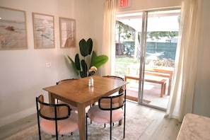 Dining table for four, leads to backyard