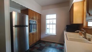 Full size refrigerator, oven and microwave. Kitchen has beautiful view of pool 
