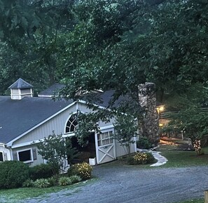 Guest area is addition to the right of barn, vaulted ceilings, hearth fireplace