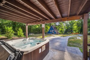 The hot tub is tucked under the deck which offers privacy. End your day soaking in the hot tub that can fit up to 7 people.