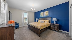 Large bedroom with TV and king-sized bed