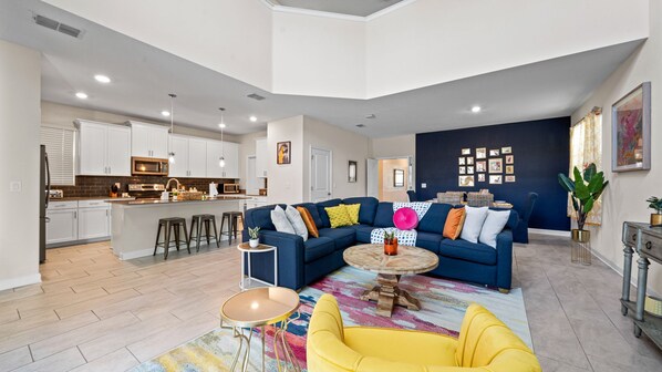 Living room with living room with large plush couch; situated beside the kitchen