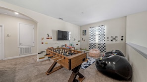 Game room with foosball, TV, and inflatable bean bags