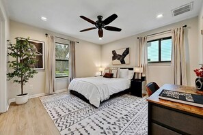 Slumber in comfort: a queen bed with crisp white sheets bathed in natural light, promising a serene awakening.