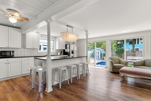 Loads of natural light through slider doors leading to the pool.