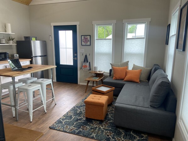 Livingroom with pull out couch and high ceilings.