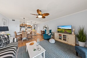 The open floor plan lets the living, dining and kitchen blend into one space. Nothing obstructs the view. With a large Smart TV for entertainment.
