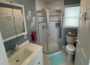 Full bathroom with hair dryer and toiletries provided.