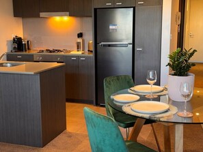 Stone benchtops in kitchen and two person dining setting