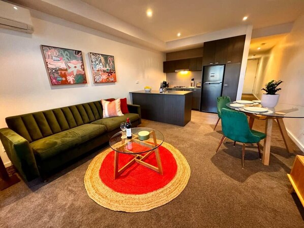 Open plan living dining kitchen with plush velvet three seater sofa