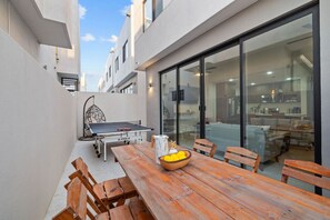 Relax outside with a game of ping pong, a comfy swing chair, and a spot for outdoor dining.